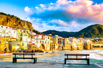sunset at the beach of Cefalu Sicily an old town of Cefalu Sicilia panoramic view of the colorful village Italy, two branch at waterfront of the coast in Sicily