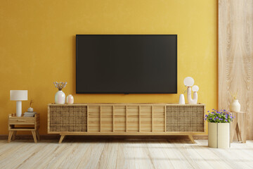 Yellow wall background,TV is mounted on a wooden cabinet in a modern living room