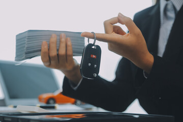 Salesman send key to customer after good deal agreement, successful car loan contract buying or selling new vehicle.