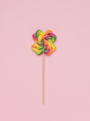 Colorful colorful lollipop on a pink background. The concept of sweets.