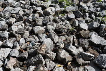 Pile of large rocks making a dam. A large pile of limestone rubble.