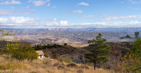 view from atop the mountain in Jerome, Arizona across the valley toward the red rock mountains of...