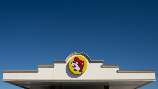 Terrell, TX - Oct. 16, 2023: The Buc-ee's logo is a beaver head in a yellow circle. Buc-ee's is a US chain of travel centers with a convenience store and gas station. Some have Tesla Superchargers.