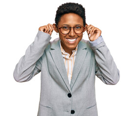 Young african american woman wearing business clothes smiling pulling ears with fingers, funny...