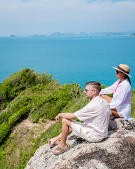 A couple of men and woman at Ko Kham tropical Island Sattahip Chonburi Samaesan Thailand - obrazy, fototapety, plakaty
