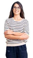 Fototapeta premium Brunette teenager girl wearing casual clothes and glasses happy face smiling with crossed arms looking at the camera. positive person.