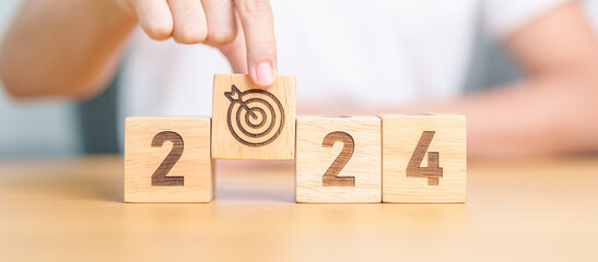 2023 year change to 2024 year block with dartboard icon. Goal, Target, Resolution, strategy, plan,...