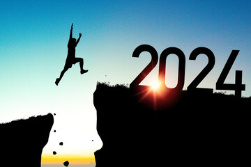 Welcome merry Christmas and happy new year in 2024,Silhouette Man jumping to 2024 cliff with yellow...