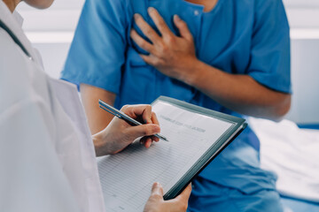 Doctor telling to patient woman the results of her medical tests. Doctor showing medical records to...