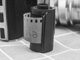 classic 135 film cassette with retro camera background  