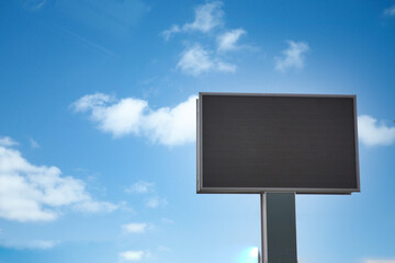 Outdoor billboard on blue sky background with black background mock up.