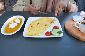 eating Plain Egg Omelette on table 