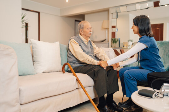 Home nurse talking to an old man during a visit