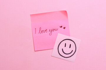 Sticky note with handwritten text I Love You on pink background