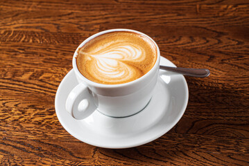 cup of cappuccino on the wooden table