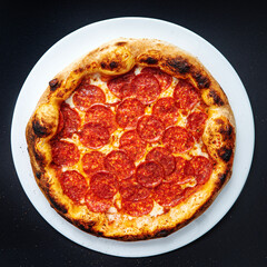 pizza on the black background, top view