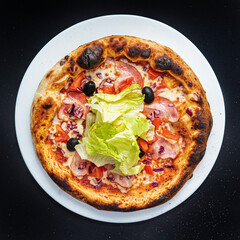 pizza on the black background, top view