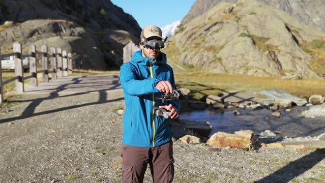 Solo Operator Launching FPV Drone Wearing Goggles On Mountain Landscape In Valmalenco