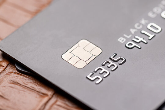 Closeup of black credit card on leather notepad