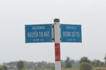 This is a Vietnamese street sign. It shows the street type at the type (Duong is a Street or Road)...