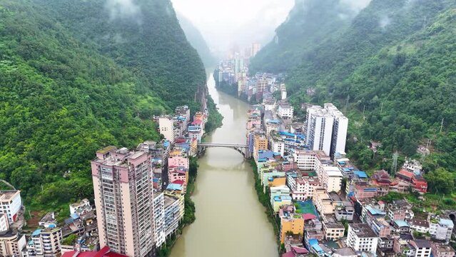 Yunnan city, Yanjin county, narrowest city in the world from high above, cloudy drone overview