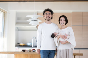 Fototapeta premium Happy portrait in front of the kitchen, looking at the camera
