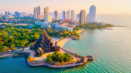 Sanctuary of Truth, Pattaya, Thailand, wooden temple by the ocean at sunset on the beach of Pattaya - Powered by Adobe