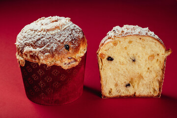 Traditional Italian Christmas cake Panettone. Artisan Pastry on red background. Close up pastry texture.