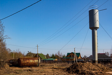 Fototapeta na wymiar A new water tower installed to replace an old rusty one in the countryside