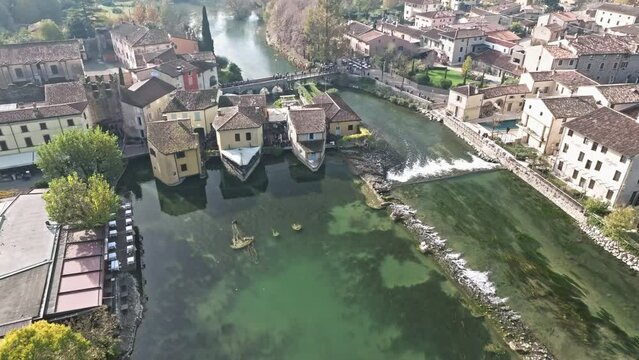 Flying On The Medieval Village With Ancient Houses In Borghetto sul Mincio In Verona, Italy. Aerial Drone Shot