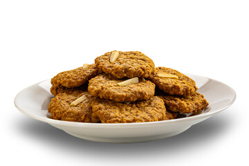 Pile of crispy delicious homemade coconut cookies in white ceramic plate isolated on white background with clipping path