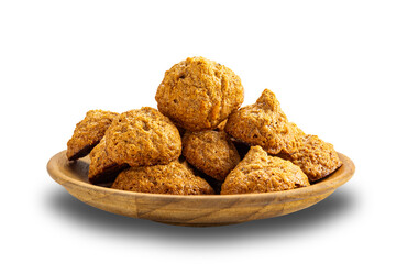 Pile of crispy delicious homemade coconut meringue cookies in wooden plate isolated on white background with clipping path.