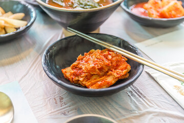 Closed up of Kimchi cabbage in a bowl with stainless steel chopsticks, Korean food