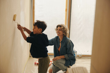 A family's joyful home transformation: Mother and son painting and renovating together