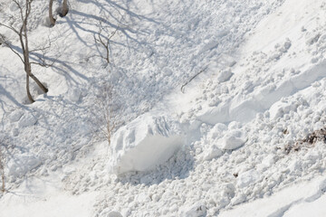 Large lump of snow at bottom of winter landscape avalanche