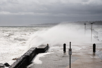 Giant Waves Crashing Over Mornington Jetty. Mornington Pier is a popular destination for a range of recreational activities including sightseeing, fishing and scuba diving.