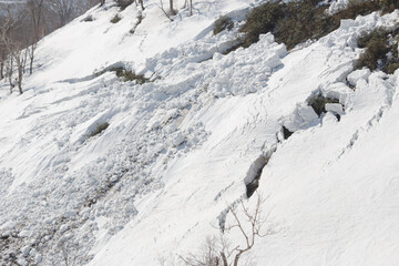 Large avalanche crack in snow on mountain in spring