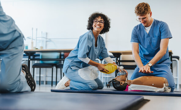 Medical ER training: Nursing students practicing CPR on a manikin