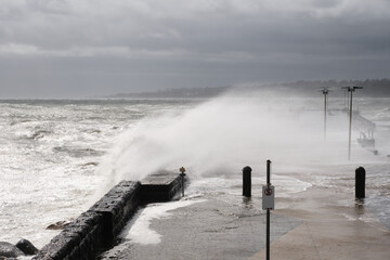 Giant Waves Crashing Over Mornington Jetty. Mornington Pier is a popular destination for a range of recreational activities including sightseeing, fishing and scuba diving.