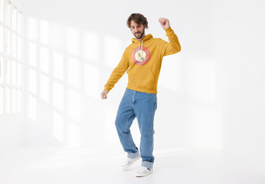 Mockup of man wearing customizable hoodie in studio, dancing