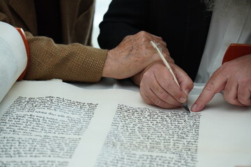hand writing of a Jewish Torah scroll with a quill or feather according to ancient Jewish tradition. - obrazy, fototapety, plakaty