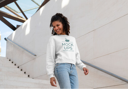 Mockup of woman wearing customizable sweatshirt coming down steps