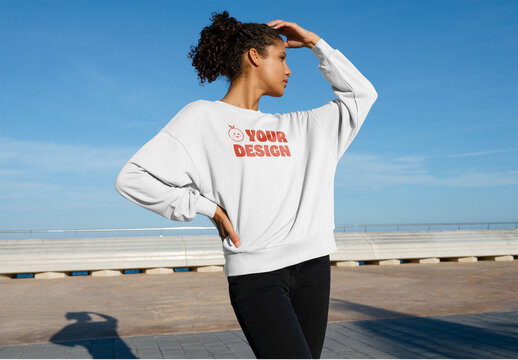 Mockup of woman wearing customizable sweatshirt, hand in hair