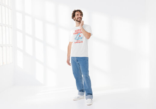 Mockup of man wearing customizable t-shirt in studio, thinking