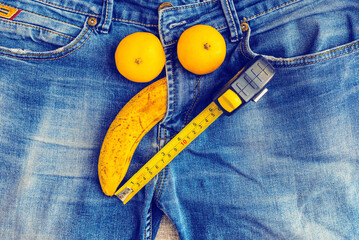 Mens denim pants with banana and measure tape imitating male genitals.Health and male sexuality concept.Closeup.