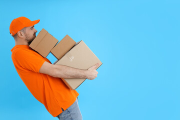Young attractive guy with cardboard boxes in hands