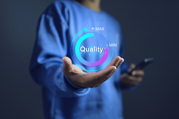 Man in blue shirt holding a quality circle to maximum level adjust represent to quality control and improvement service and products for best customer experience and satisfaction