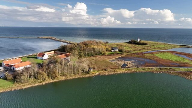 Aerial footage along Denmark's coastline towards to Knudshoved Lighthouse. Knudshoved Lighthouse against the backdrop of the vast sea.