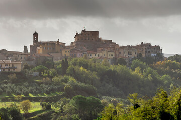 Panoramic view of the picturesque Tuscan village of Lari, Pisa, Italy, under a dramatic sky