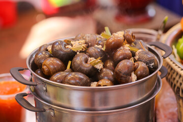 Closeup of Snails Stuffed With Pork on street food, Ho Chi Minh City, Vietnam